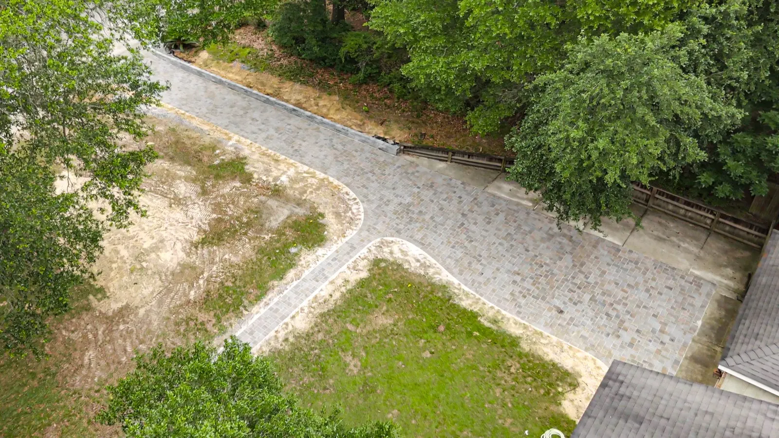 Aerial view of a full paver driveway run leading to a two-car garage at a home in Baldwin County, Alabama
