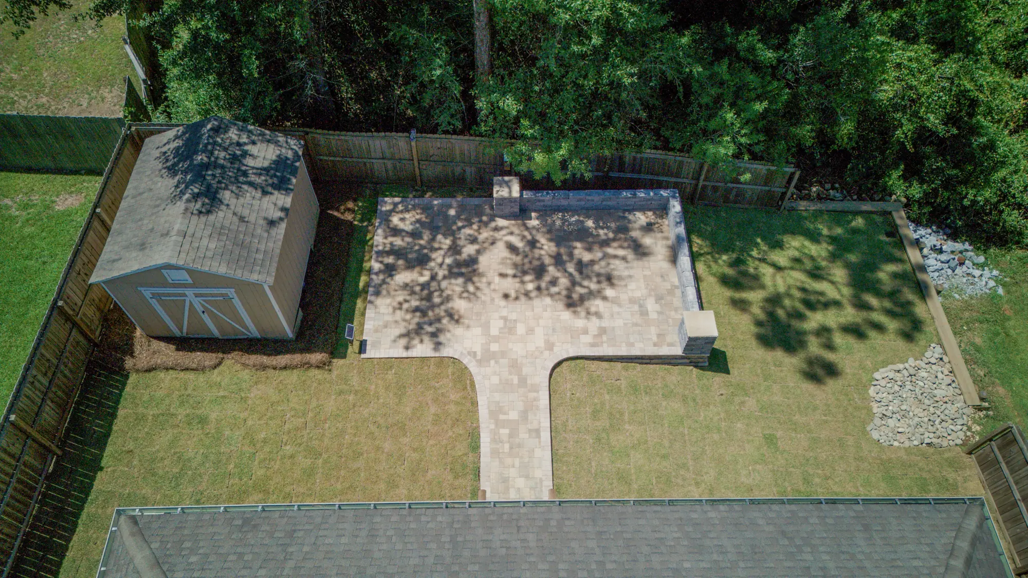 Aerial view of a finished paver patio and backyard in Baldwin County, Alabama