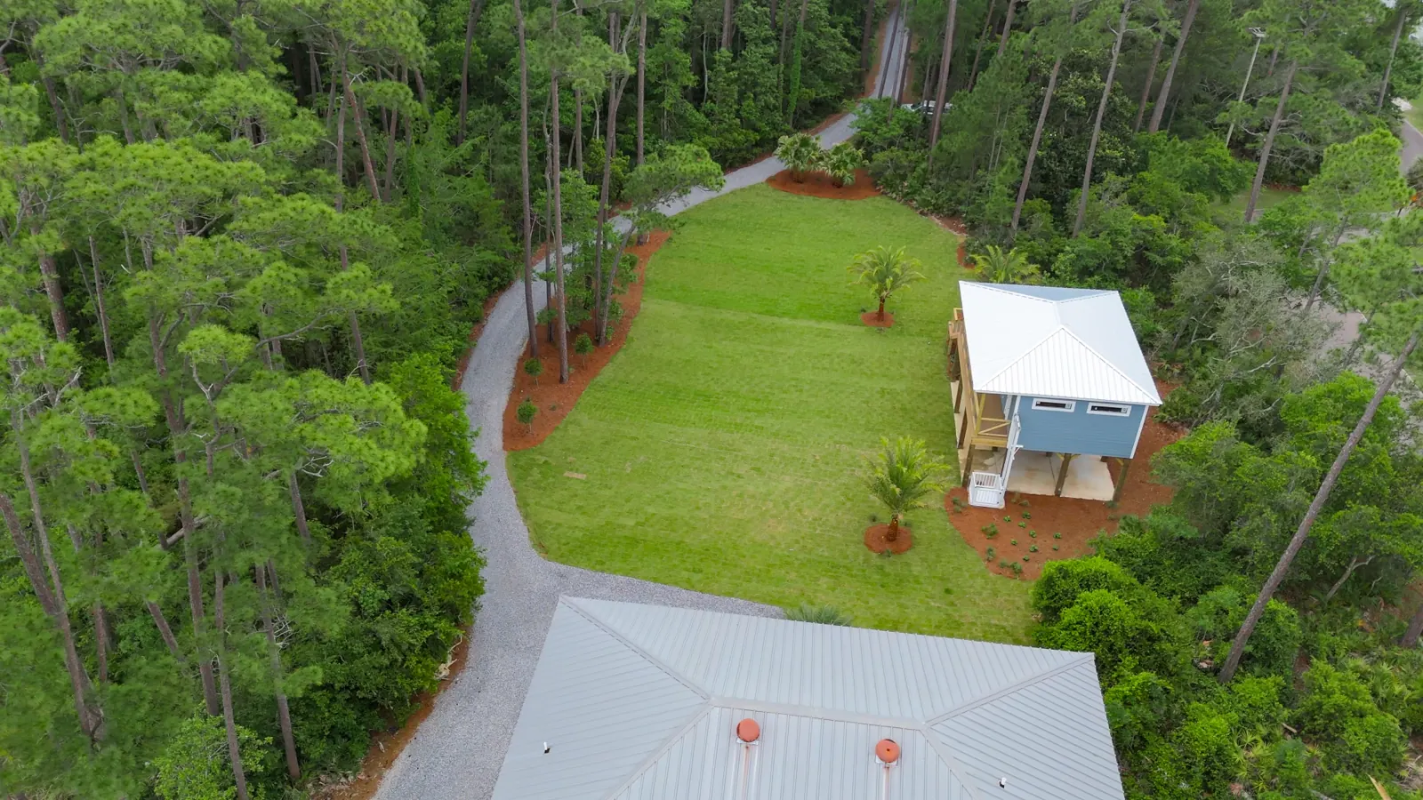 Finished gravel driveway, fresh sod lawn and mulch beds at a Gulf Shores, Alabama property