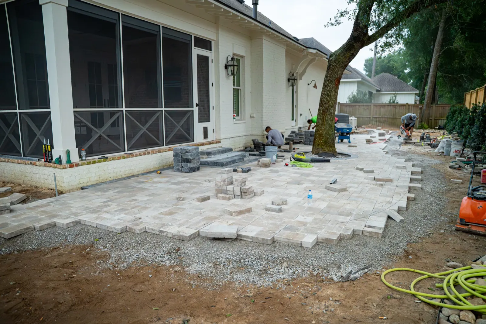 New paver patio installation in progress in a backyard in Point Clear, Alabama
